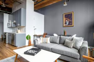 a living room with a couch and a table at Bright Fort Point Studio w WD in Unit BOS-260 in Boston
