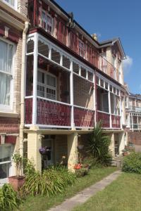 an old house with a balcony on the side of it at Cleve Court Hotel in Paignton