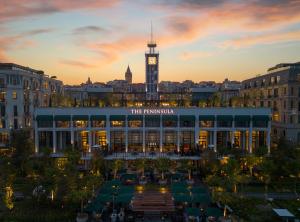 ein Gebäude mit einem Uhrturm in der Stadt in der Unterkunft The Peninsula Istanbul in Istanbul