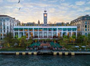 a large building with a clock tower in a city at The Peninsula Istanbul in Istanbul