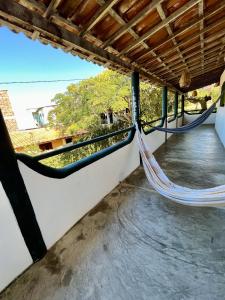 a couple of hammocks on a balcony at Padang Hostel in Pipa