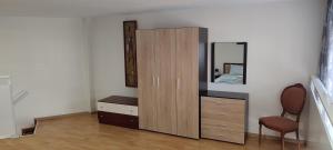 a bedroom with a dresser and a mirror at Marianna's apartment 2 in Nea Moudania