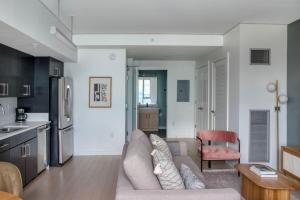 a living room with a couch and a kitchen at Pioneer Square studio w lounge gym nr bay SEA-587 in Seattle