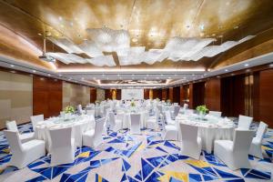 a conference room with white tables and white chairs at Swissôtel Grand Shanghai in Shanghai