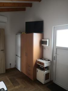 a small kitchen with a refrigerator and a microwave at Ceremoniár in Poľný Kesov