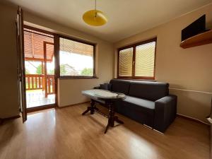 a living room with a couch and a table at Penzion Siesta Grand in Hrabušice