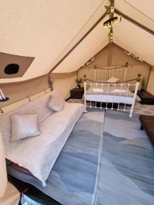 a bedroom in a tent with a bed in it at Glamping in style, Prospector Tent in Crawley