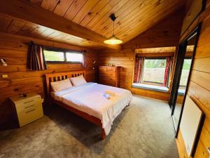 a bedroom with a bed in a wooden cabin at Auckland Beachview Homestay with free Netflix, Parking in Auckland