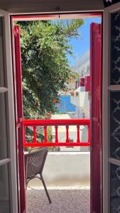 an open door with a chair looking out at the ocean at Anna Studios in Katapola