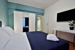 a bedroom with a bed with towels on it at Melia Residence Acropolis - NEW in Athens
