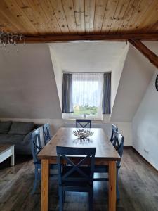 a dining room with a wooden table and chairs at Gaststätte und Pension Zur Schiene in Merseburg
