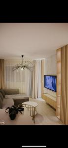 a living room with a couch and a table and a tv at Luxury Apartment in Lukavac