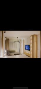 a bedroom with a bed and a television in it at Luxury Apartment in Lukavac