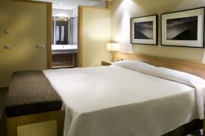 a bedroom with a white bed and a window at Hotel Playa Calera in Valle Gran Rey