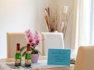 two bottles of wine sitting on a table with a sign at Holiday Home Boddenrauschen by Interhome in Ummanz