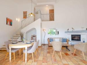 a living room with a table and chairs at Villa Clos Romain by Interhome in Les Issambres