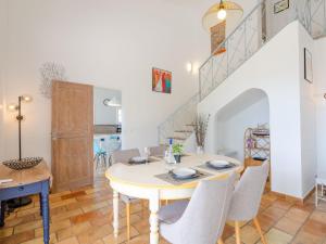 a dining room with a table and chairs at Villa Clos Romain by Interhome in Les Issambres