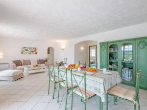 a kitchen and living room with a table and chairs at Holiday Home Mas des Chênes - GRI120 by Interhome in Grimaud