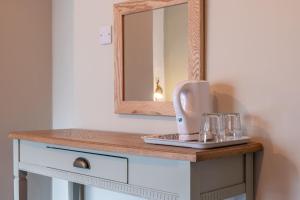 a hair dryer on a counter with a mirror at Woodroffe Arms, Hope Room 4 in Hope
