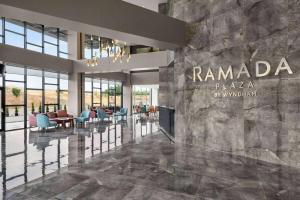 a lobby of a hotel with a sign that reads ramada plaza by wyn at Ramada Plaza By Wyndham Batman in Batman
