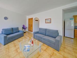 a living room with two blue couches and a table at Apartment Gavrena by Interhome in Fanadix