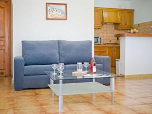 a living room with a couch and a table with wine glasses at Apartment Gavrena by Interhome in Fanadix