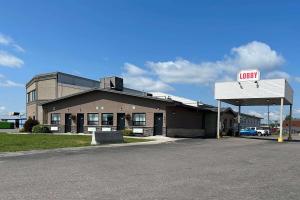 a mobil gas station with a sign in front of it at Howard Johnson by Wyndham Thunder Bay in Thunder Bay