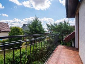 a balcony with a black fence and trees at Holiday Home Sianożęty by Interhome in Sianozety
