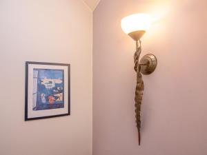 a light on a wall next to a picture at Holiday Home Sianożęty by Interhome in Sianozety
