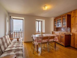 a dining room with a table and a balcony at Apartment Vetan by Interhome in Saint Nicolas