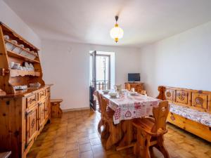 a dining room with a table and wooden furniture at Apartment Vetan by Interhome in Saint Nicolas