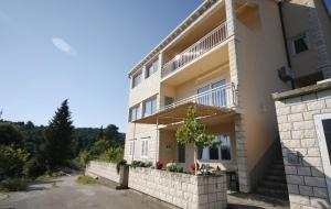 a large white building with a fence in front of it at Apartment Rose in Korčula