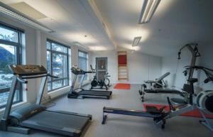 a gym with several treadmills and machines in a room at Bøvervegen 19 Appartment nr 9 in Bjorli