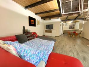 a living room with a red couch and a bed at Arno Loft in Florence