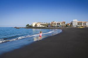 a little girl running on the beach at Hotel Playa Calera in Valle Gran Rey
