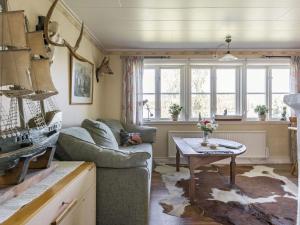 a living room with a couch and a table at Holiday Home Lidelund by Interhome in Tingsryd