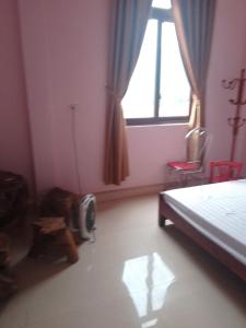 a bedroom with a bed and a window at New Homestay in Ha Giang