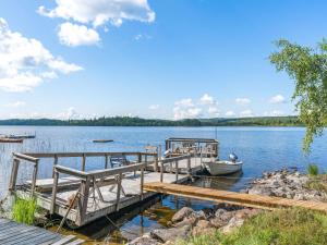 a dock with a boat on a lake at Chalet Uskeboda - VML215 by Interhome in Nora