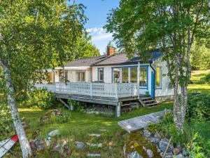 a cottage with a porch and a bench in the yard at Chalet Uskeboda - VML215 by Interhome in Nora