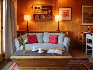 a living room with a couch and a coffee table at Apartment Argentière 8 by Interhome in Villars-sur-Ollon