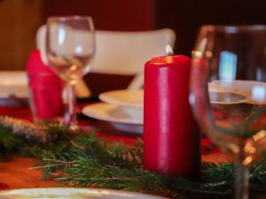 a red candle sitting on top of a table at Apartment Argentière 8 by Interhome in Villars-sur-Ollon