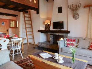 a living room with a couch and a fireplace at Apartment Argentière 8 by Interhome in Villars-sur-Ollon
