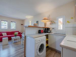 a kitchen and living room with a washing machine at Apartment Pointe Vermeille-5 by Interhome in Le Barcarès