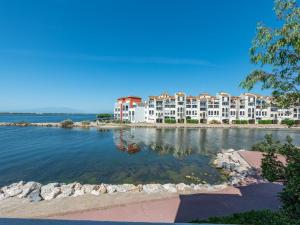 a view of a large apartment complex on a body of water at Apartment Pointe Vermeille-5 by Interhome in Le Barcarès
