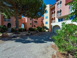 an apartment complex with a tree and a driveway at Apartment Pointe Vermeille-5 by Interhome in Le Barcarès