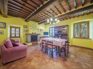 a living room with a table and chairs and a couch at Holiday Home Sara by Interhome in Gello