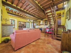 a living room with a pink couch and a table at Holiday Home Sara by Interhome in Gello +42 photos