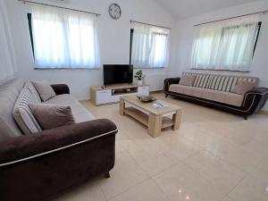 a living room with two couches and a tv at Holiday Home Bili dvori by Interhome in Čaporice