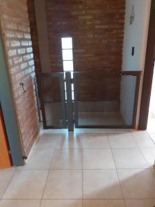 an empty room with a door and a tile floor at Los algarrobos in Villa Carlos Paz