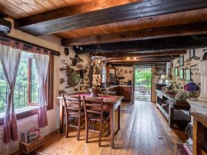 a kitchen with a wooden table and chairs at Chalet Il Gianlupo by Interhome in Bognanco